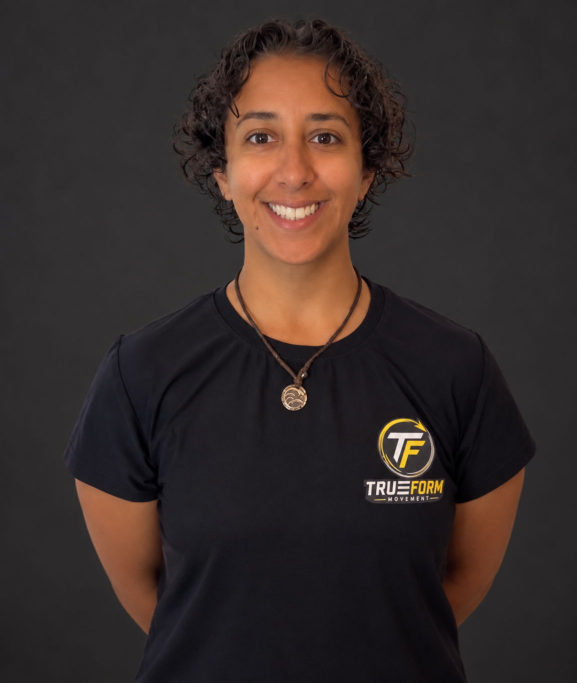Coach Maria smiling in her TrueForm Movement shirt